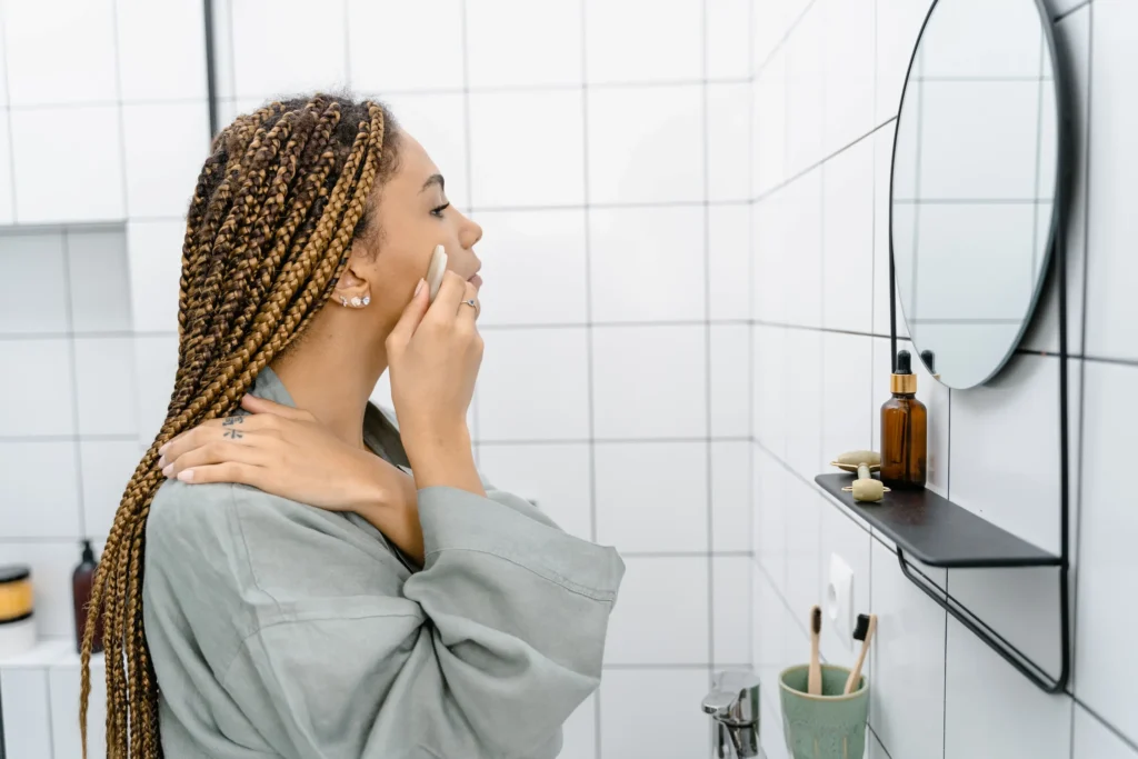 Woman following an acne skincare guide with a gentle cleansing and moisturizing routine for acne-prone skin
