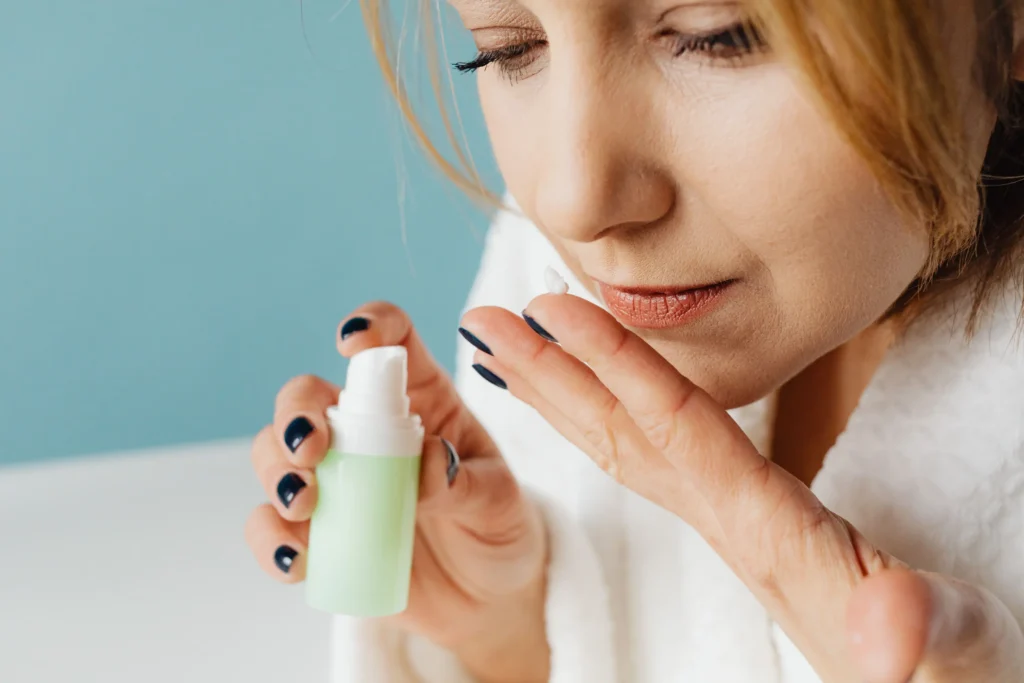 Woman applying the best ceramide cream for dry skin to improve hydration and strengthen the skin barrier