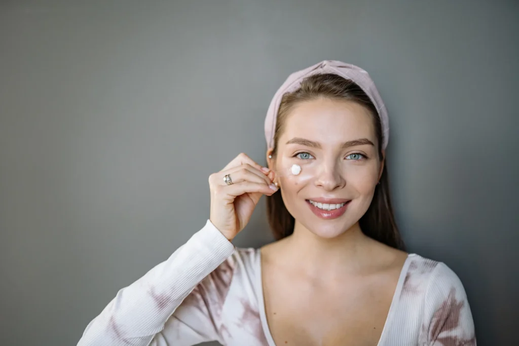Woman applying mineral sunscreen for sensitive skin and daily UV protection