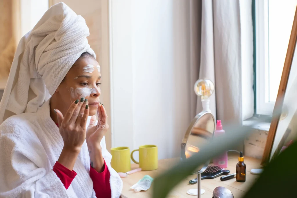 Woman applying vitamin C serum during a morning skincare routine to help improve skin radiance and support a brighter-looking complexion