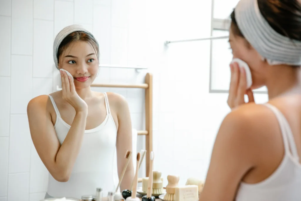 Woman following an acne skincare guide with a gentle cleansing and moisturizing routine for acne-prone skin