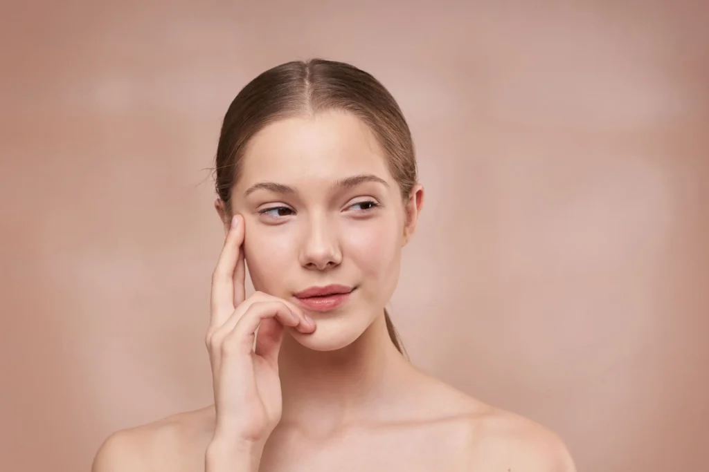 Woman with combination skin balancing an oily T-zone and dry cheeks
