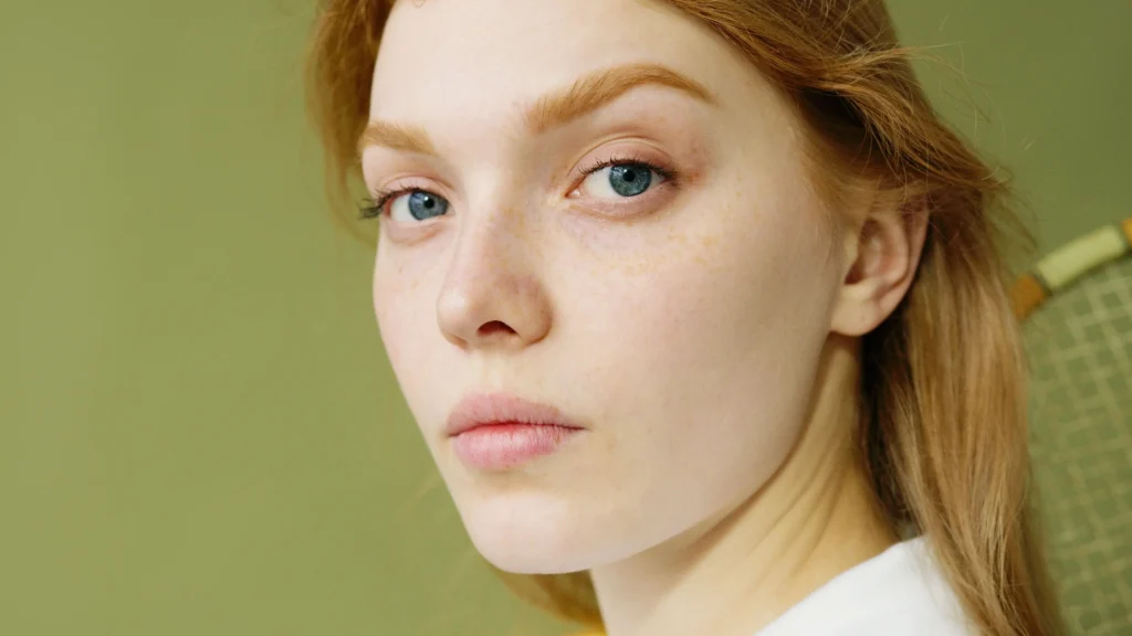 Woman with combination skin balancing an oily T-zone and dry cheeks