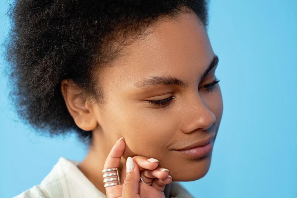 Woman with combination skin balancing an oily T-zone and dry cheeks