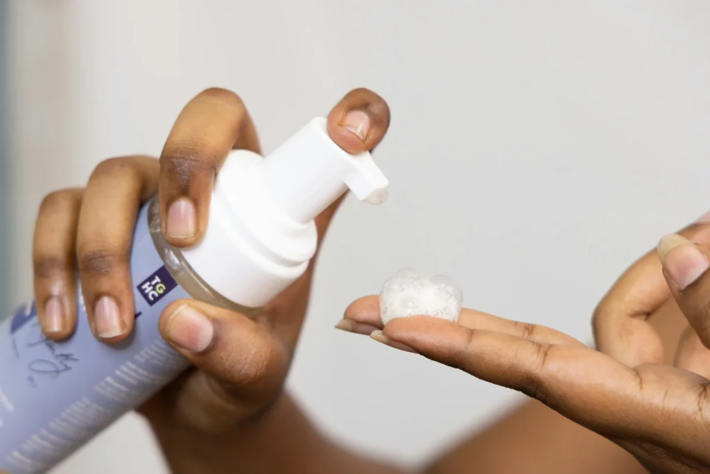 Woman cleansing face with mild facial cleanser