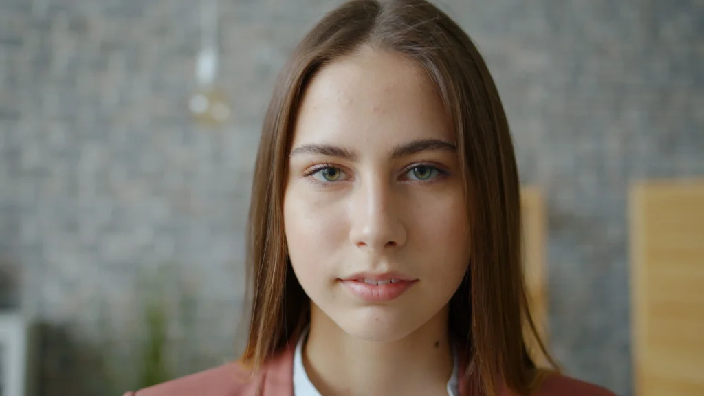 Woman with oily skin cleansing excess oil from her face