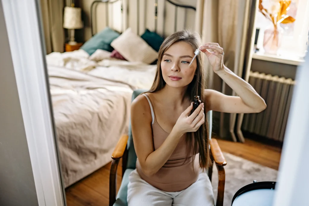 Person applying retinol serum during an evening skincare routine to support smoother-looking skin and improved skin texture