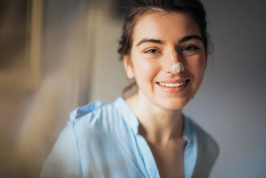 Woman with oily skin cleansing excess oil from her face