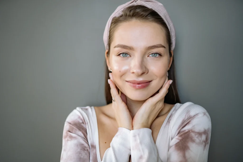 Woman with oily skin cleansing excess oil from her face