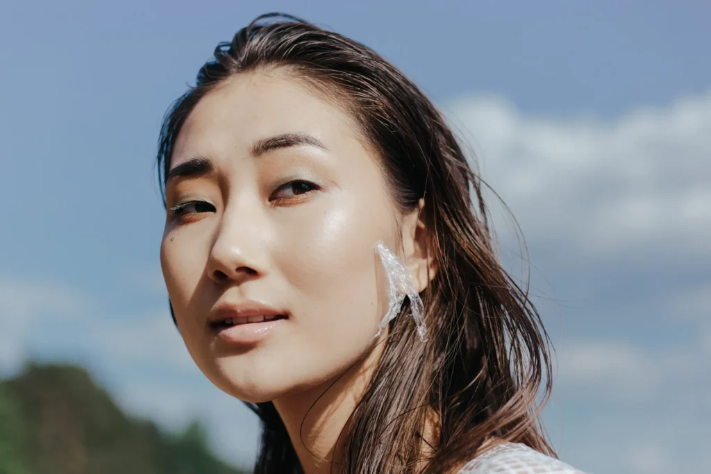 Woman with oily skin cleansing excess oil from her face