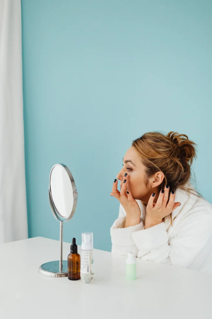 Person applying retinol serum during an evening skincare routine to support smoother-looking skin and improved skin texture