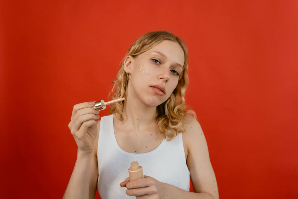 Person applying retinol serum during an evening skincare routine to support smoother-looking skin and improved skin texture