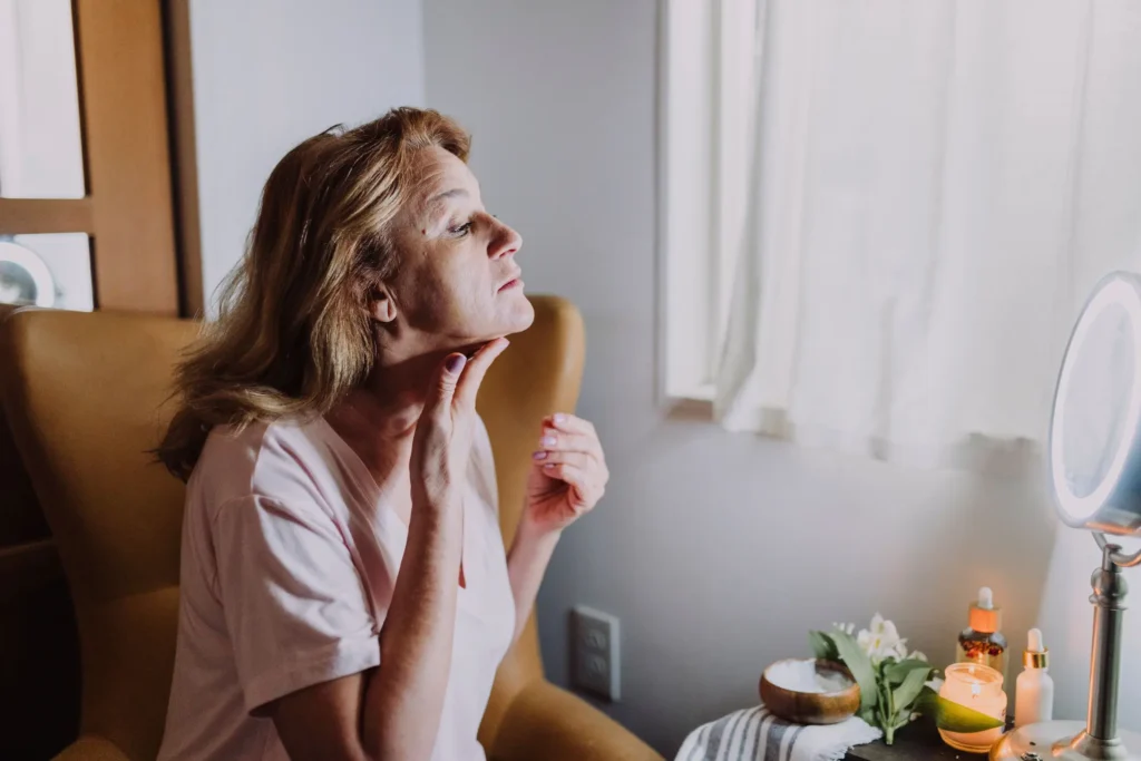 Person applying retinol serum during an evening skincare routine to support smoother-looking skin and improved skin texture