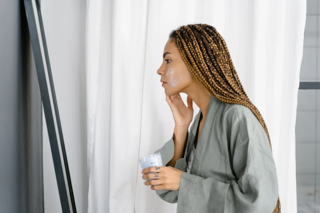 Person following a sensitive skin care guide using gentle skincare products to soothe and protect the skin barrier