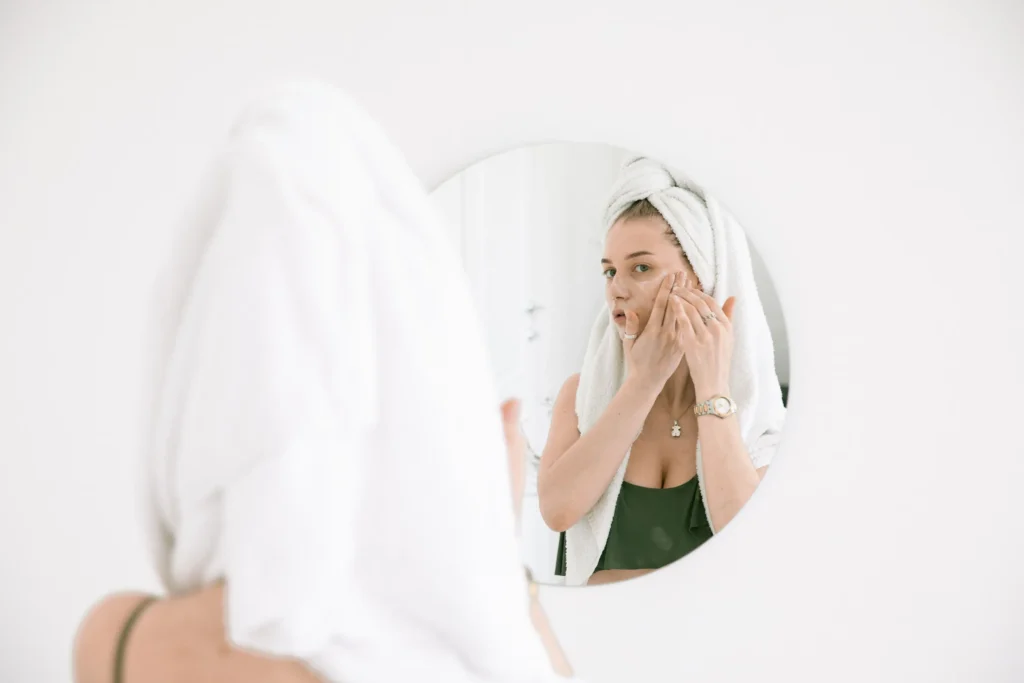 Person following a sensitive skin care guide using gentle skincare products to soothe and protect the skin barrier