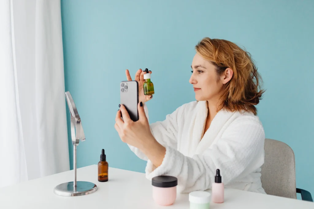 Woman applying vitamin C serum during a morning skincare routine to help improve skin radiance and support a brighter-looking complexion