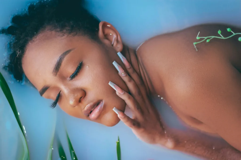 Woman exfoliating her face as part of a healthy skincare routine for every skin type