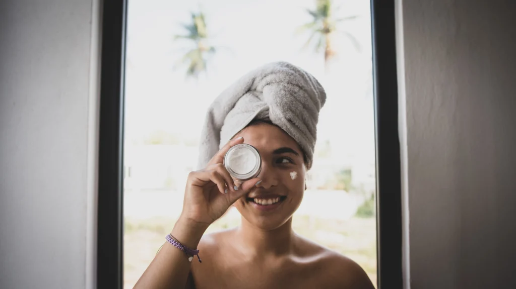 Woman applying a ceramide moisturizer to strengthen the skin barrier and improve healthy skin