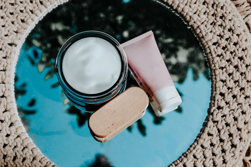 Beginner skincare routine featuring cleanser, moisturizer, sunscreen, and serum arranged on a clean bathroom counter.