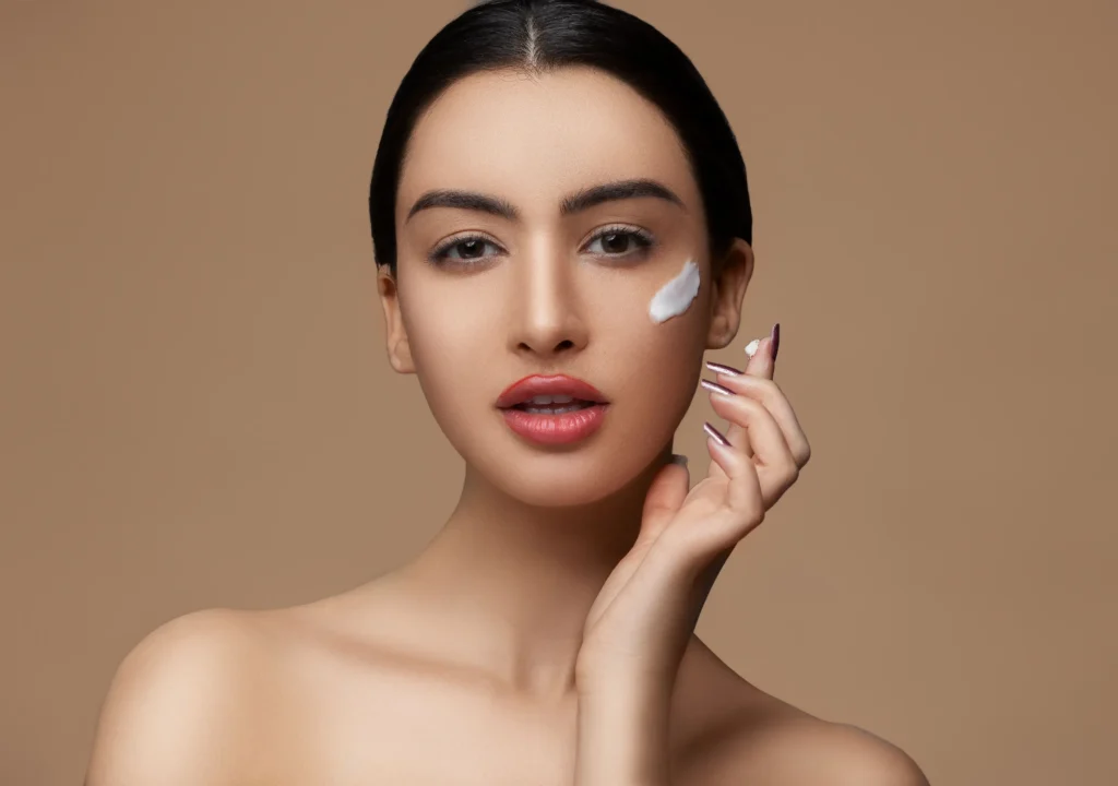 Woman applying a ceramide moisturizer to strengthen the skin barrier and improve healthy skin