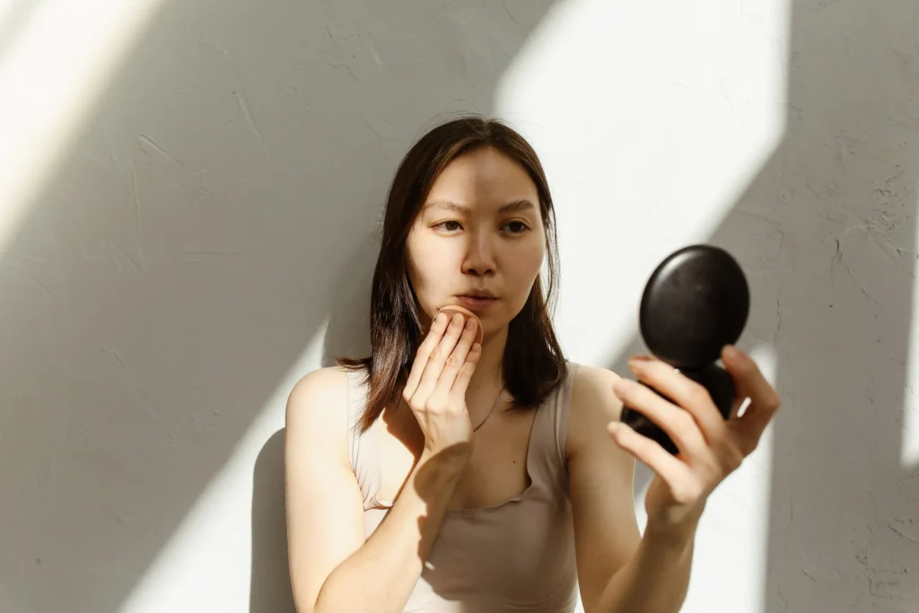 Woman applying a ceramide moisturizer to strengthen the skin barrier and improve healthy skin