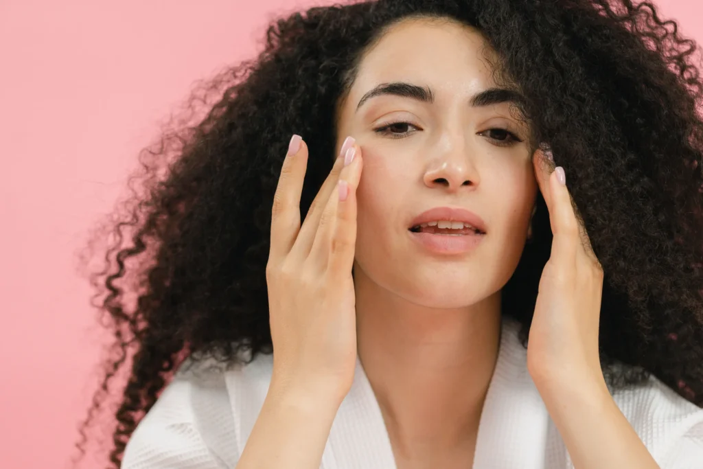 Woman applying a ceramide moisturizer to strengthen the skin barrier and improve healthy skin