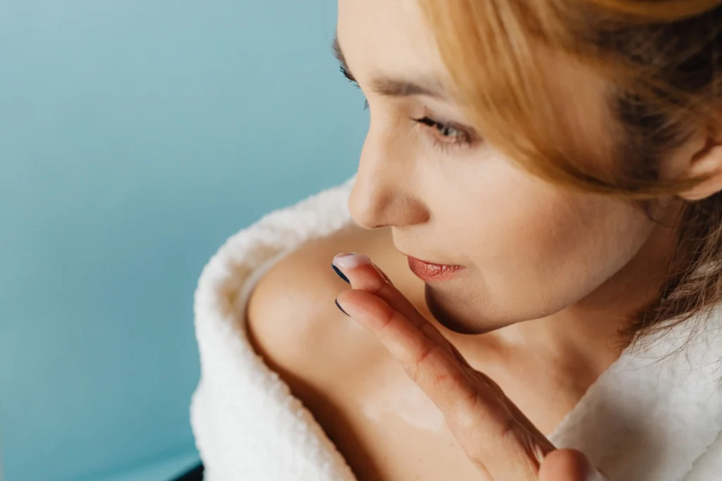 Woman applying a ceramide moisturizer to strengthen the skin barrier and improve healthy skin