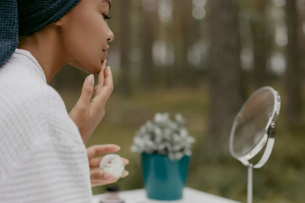 Woman applying a ceramide moisturizer to strengthen the skin barrier and improve healthy skin