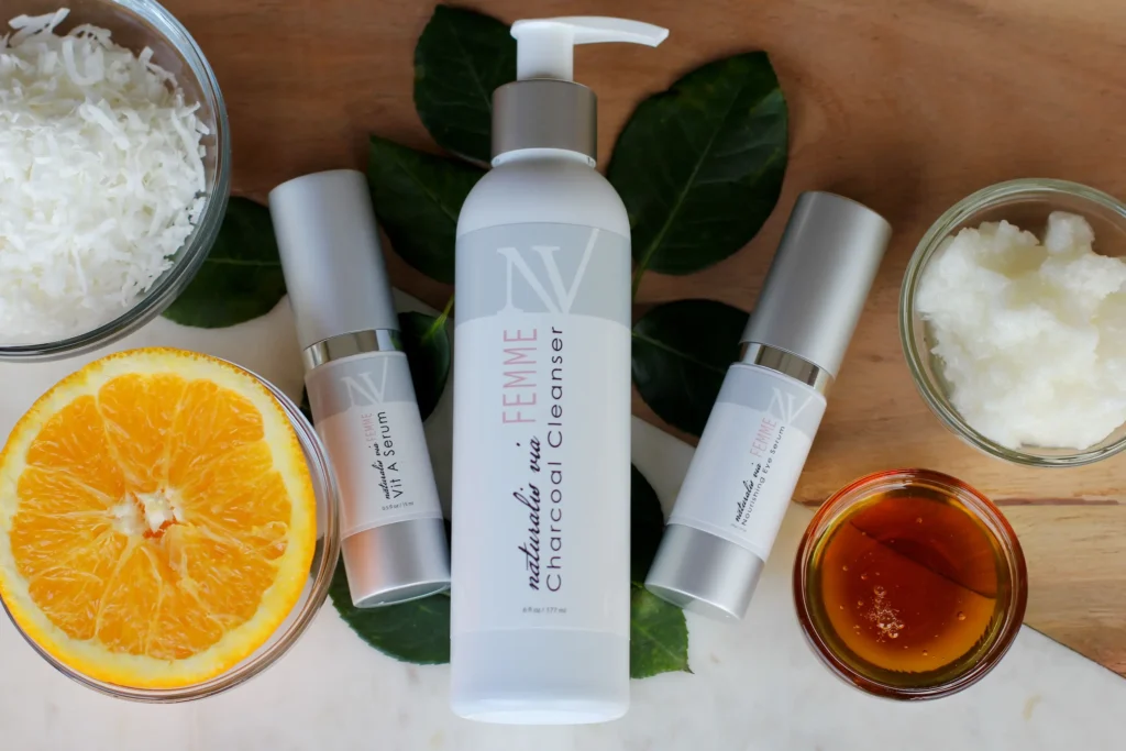 Beginner skincare routine featuring cleanser, moisturizer, sunscreen, and serum arranged on a clean bathroom counter.