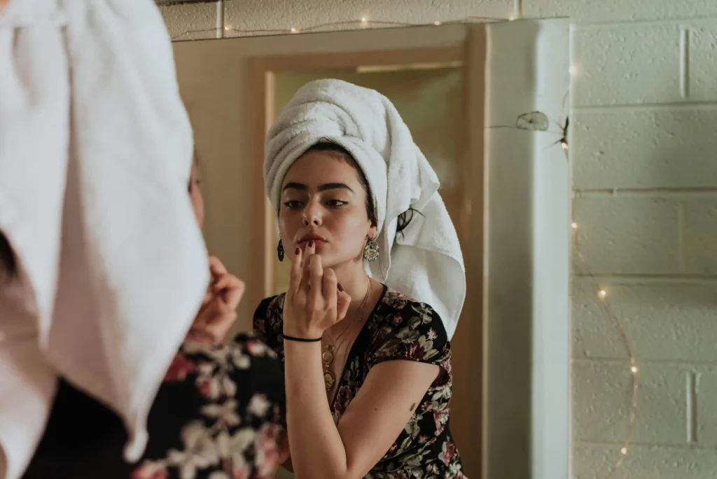 Woman exfoliating her face as part of a healthy skincare routine for every skin type